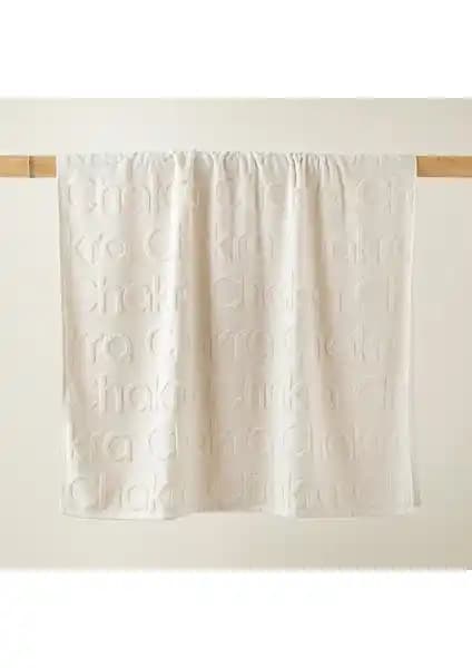 Chakra Logolu Ekru Plaj Havlusu Şıklık ve Fonksiyonellik Sunar